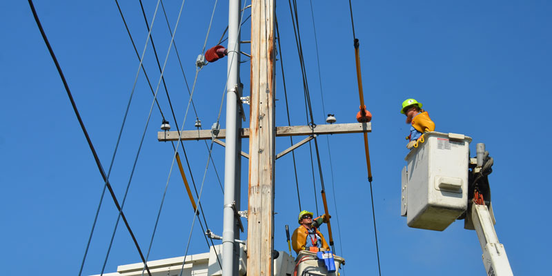 two utility workers working on power lines
