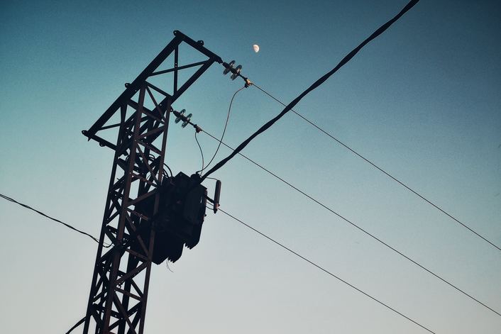 electrical transformer suspended on utility pole