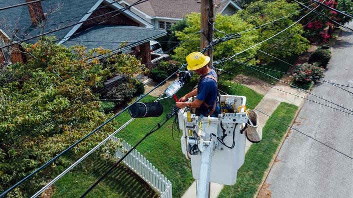utility worker repairing power line