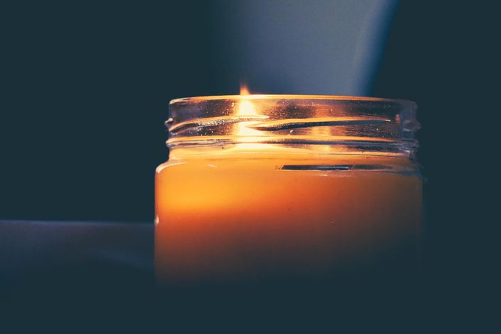 candle lit in home to provide light during power outage