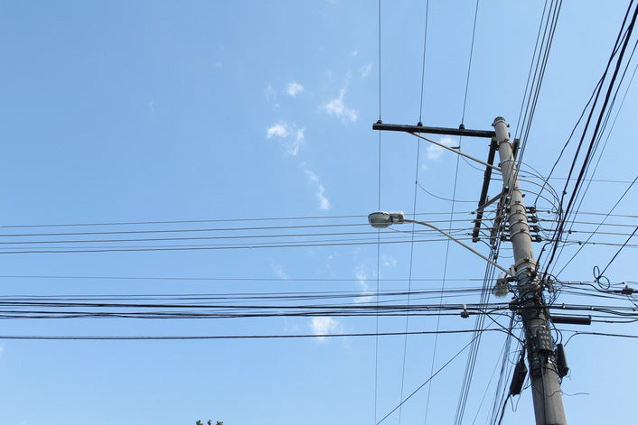 steel utility pole with many power lines