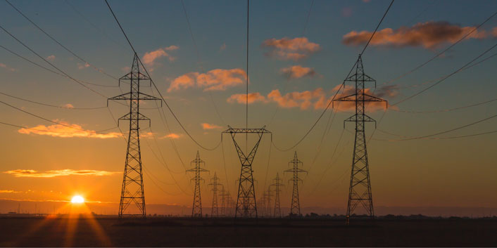 electrical lines and pylon trusses at sunrise