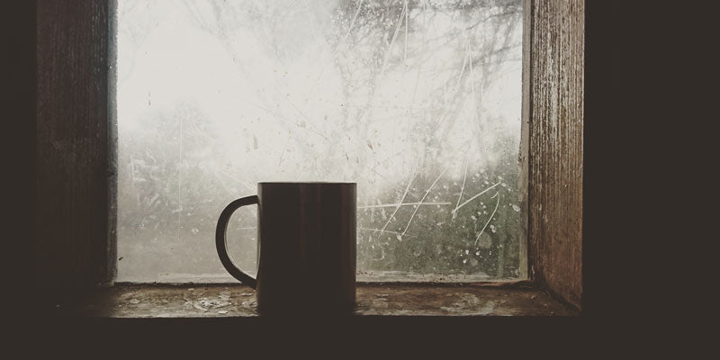 mug in windowsill on icy winter day