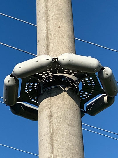 close up of pole guard on steel utility pole