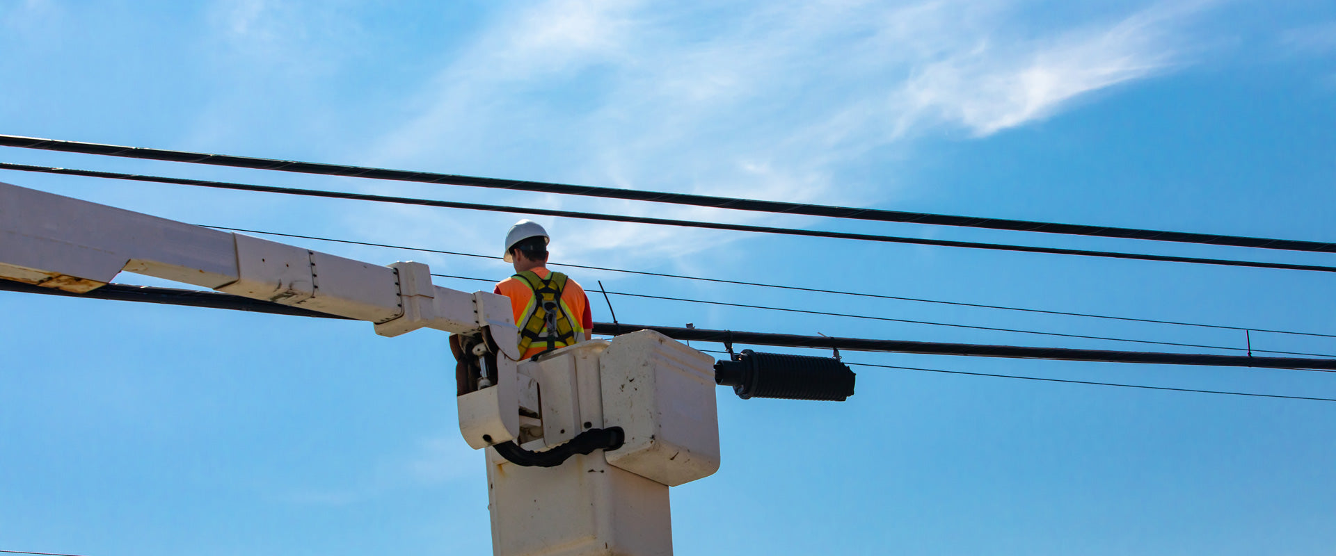 lineman working on overhead telecommunications lines