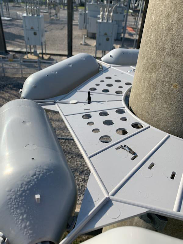 close up of pole guard installed on steel utility pole