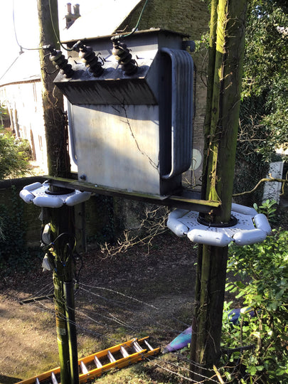 two pole guards protecting a power transformer